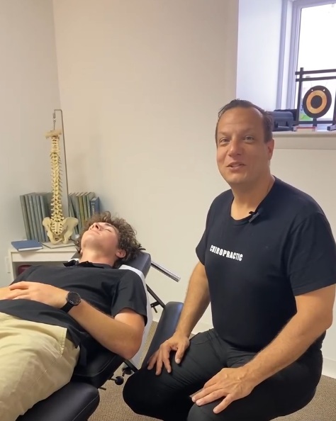 Chiropractor performing a spinal adjustment on an adolescent scoliosis patient at Cucci Chiropractic.