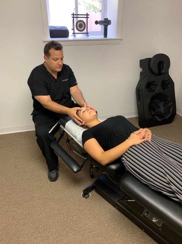 hiropractor at Cucci Chiropractic performing a spinal adjustment to correct misalignments and support nervous system function