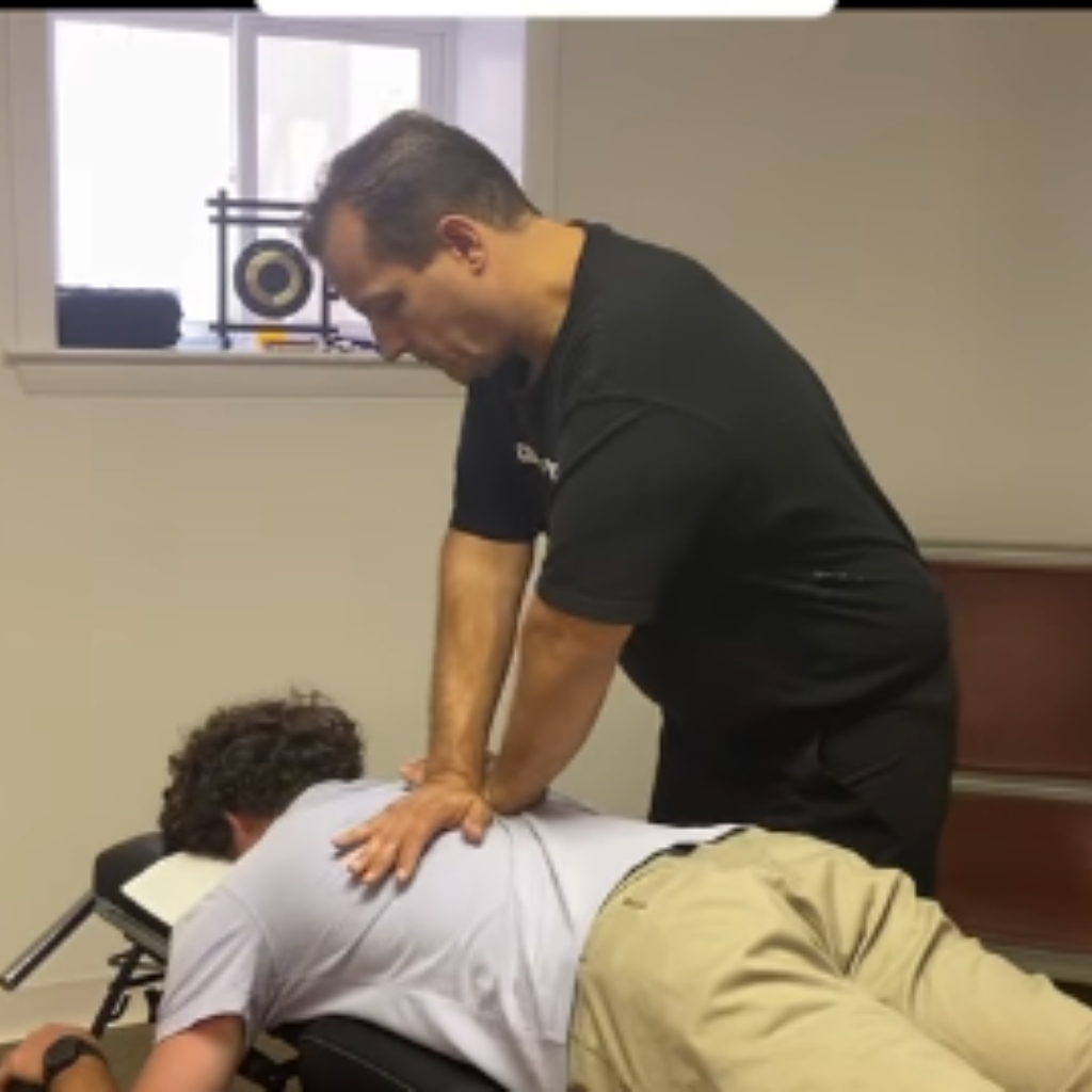 Chiropractor performing a lower back spinal adjustment on a patient at a New York, NY chiropractic clinic.
